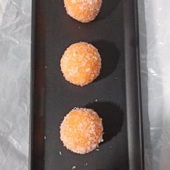 A picture of Orange Coconut ladoos.