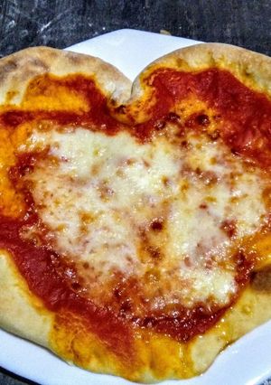 A picture of Margherita Pizza on a Pizza Stone.