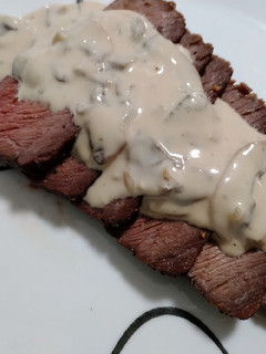 A picture of Roast beef with blue cheese mushroom sauce.