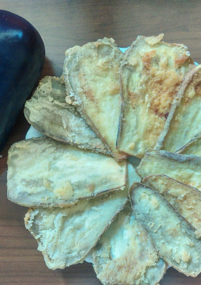 Una foto de Berenjenas rebozadas de queso parmesano