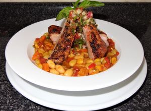 Una foto de Costillar de cerdo asado con porotos granados al pilco y pebre con albahaca. JON STYLE