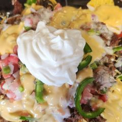 A picture of 4 Cheese loaded nachos.