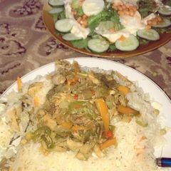 Chinese rice with chicken sauce and salad A picture of Chinese rice with chicken sauce and salad.
