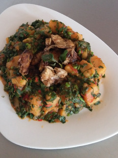 A picture of Yam Porridge with Barbequed Chicken.