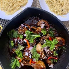 A picture of Sticky Soya sauce chicken served with Aglio olio noodles.