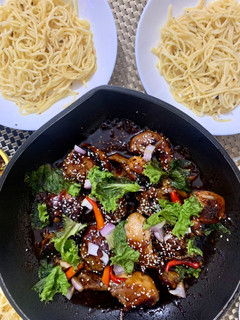 A picture of Sticky Soya sauce chicken served with Aglio olio noodles.