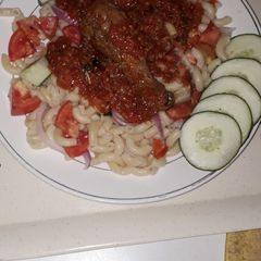 A picture of Veg macrony with chicken stew.