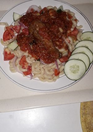 A picture of Veg macrony with chicken stew.