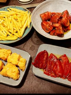 Una foto de Bacalao a la romana, con pimiento caramelizado, patatas caseras y tomate aliñado