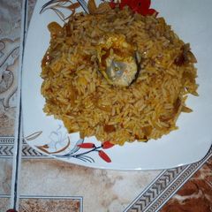 A picture of Palm oil rice with mackerel.