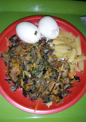 A picture of Stir fried veggies with fried Irish and eggs.