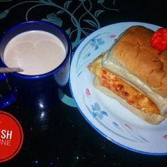 A picture of Egg sandwich and a cup of hot tea.