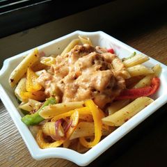 A picture of Penne pasta with fish balls.