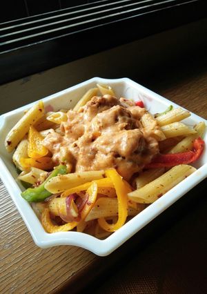 A picture of Penne pasta with fish balls.