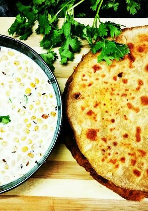 A picture of Alu paneer paratha serve with boondi raita.