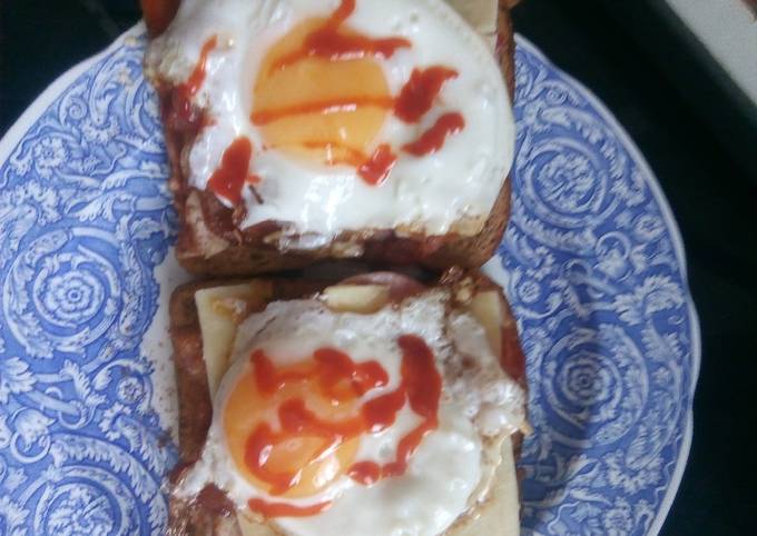 Sausage, egg, bacon and cheese sandwich with hot sauce