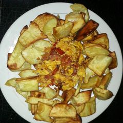 A picture of Fried sweet potatoes with fried eggs.