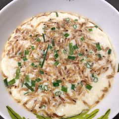A picture of Steam Egg with Tiny Shrimps and Onion Leaves.