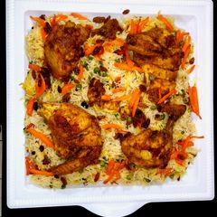 A picture of Chicken Tikka masala with bukhari rice.