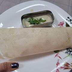 A picture of Plain dosa with white chutney.