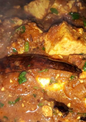A picture of Paneer masala with Parantha and white butter.