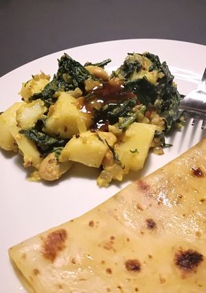 A picture of Vegan spinach, potato and bean dry curry.