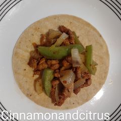 A picture of Pork Al pastor with sauteed onions and peppers.