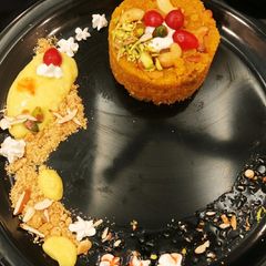 A picture of Moong halwa surprise with custard & cookies.