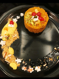 A picture of Moong halwa surprise with custard & cookies.