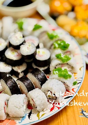A picture of Two types of rolls with crab sticks.