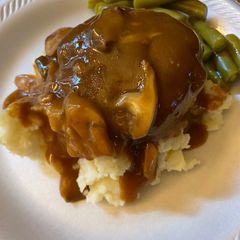 A picture of Simple Salisbury steaks over mashed potatoes.