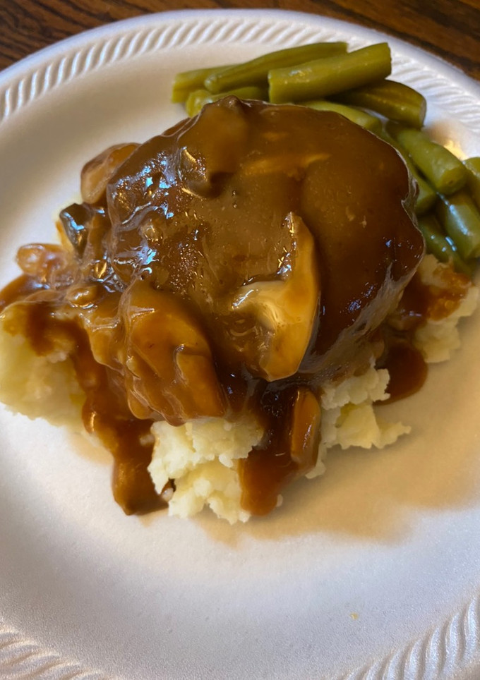 A picture of Simple Salisbury steaks over mashed potatoes.