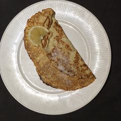 A picture of Pancakes with sugar and lemon.