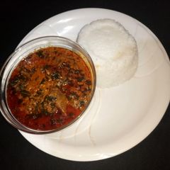A picture of Egusi soup with tuwan shinkafa.