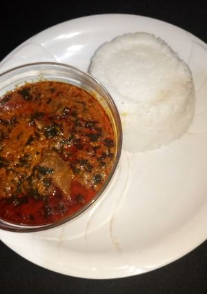 A picture of Egusi soup with tuwan shinkafa.