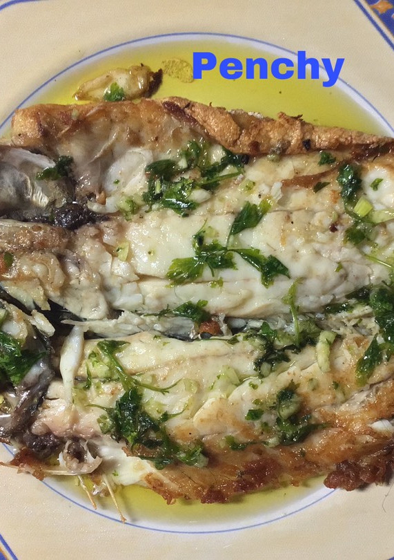 Una foto de Lubina a la espalda con ajo aceite