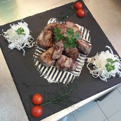 A picture of Swine steak on vulcano stones grill.