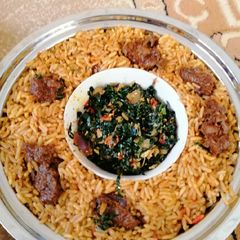 A picture of Jollof rice with spinach sauce.