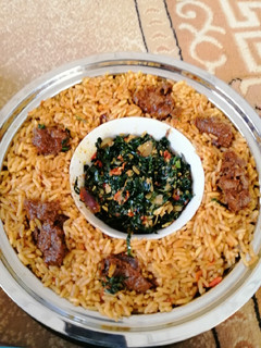 A picture of Jollof rice with spinach sauce.