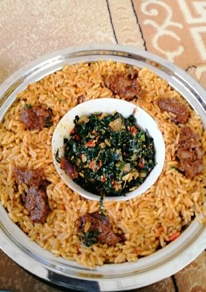 A picture of Jollof rice with spinach sauce.