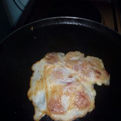 A picture of Smokie fried in egg.