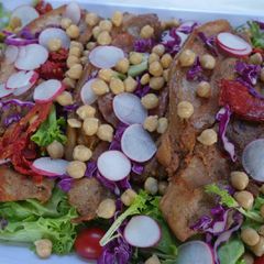A picture of Roasted Pork Fillets on Mixed Leaves Salad.