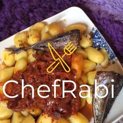 A picture of Boiled potatoes,fried fish and sauce.