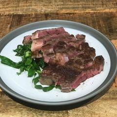 A picture of Dry aged sirloin, green salad, horseradish dressing.