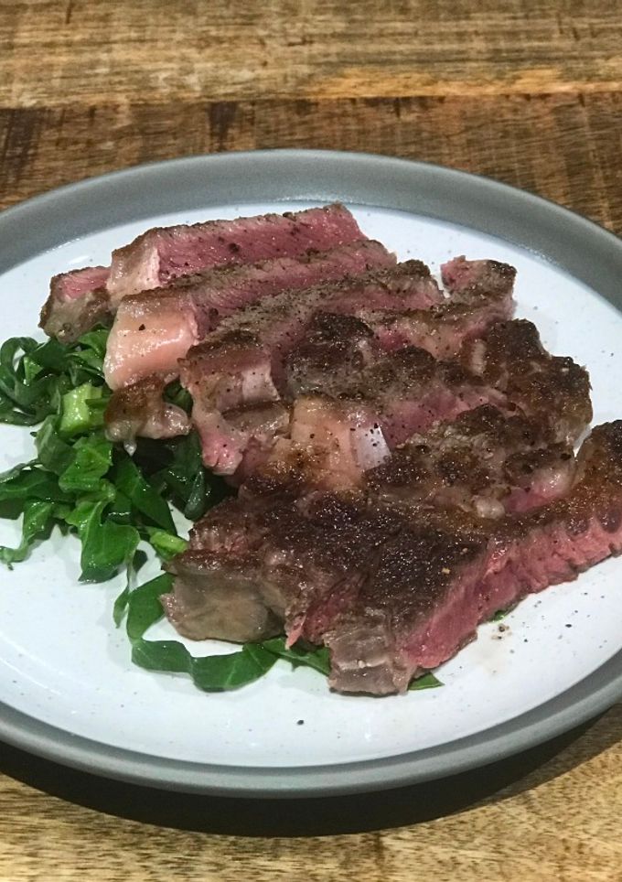 A picture of Dry aged sirloin, green salad, horseradish dressing.