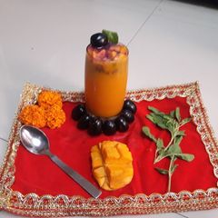 A picture of Mango mastani with black jamun.