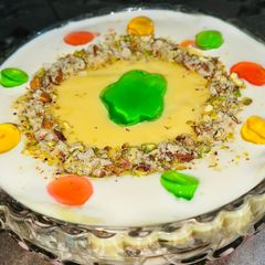 A picture of Custard with Fruit and colourful Jellies.