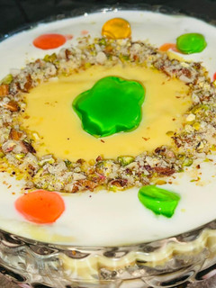 A picture of Custard with Fruit and colourful Jellies.
