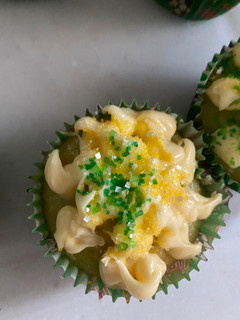A picture of Vanilla cupcakes with vanilla frosting and sugar sprinkle.