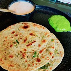 A picture of Foxtail Millets peanut Rotla with mayo Sauce and green chutney.